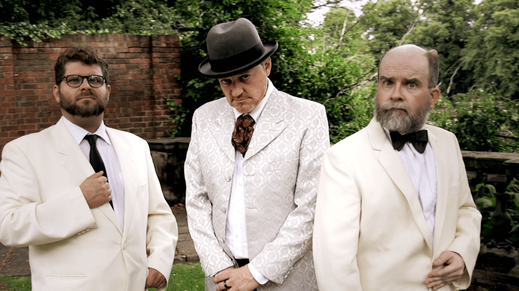 Men in suits at a themed murder mystery event