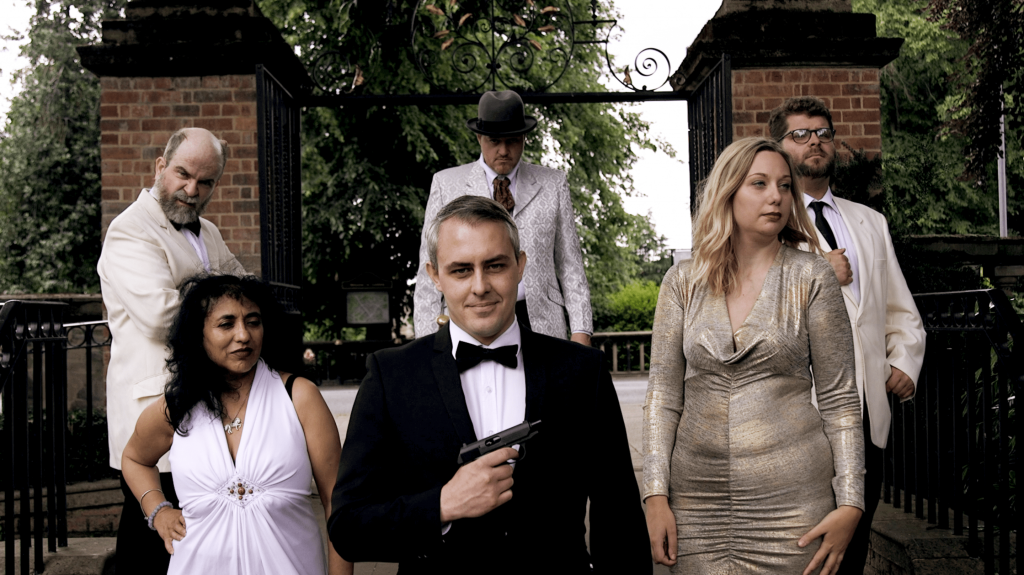 A group of well dressed actors at a murder mystery party